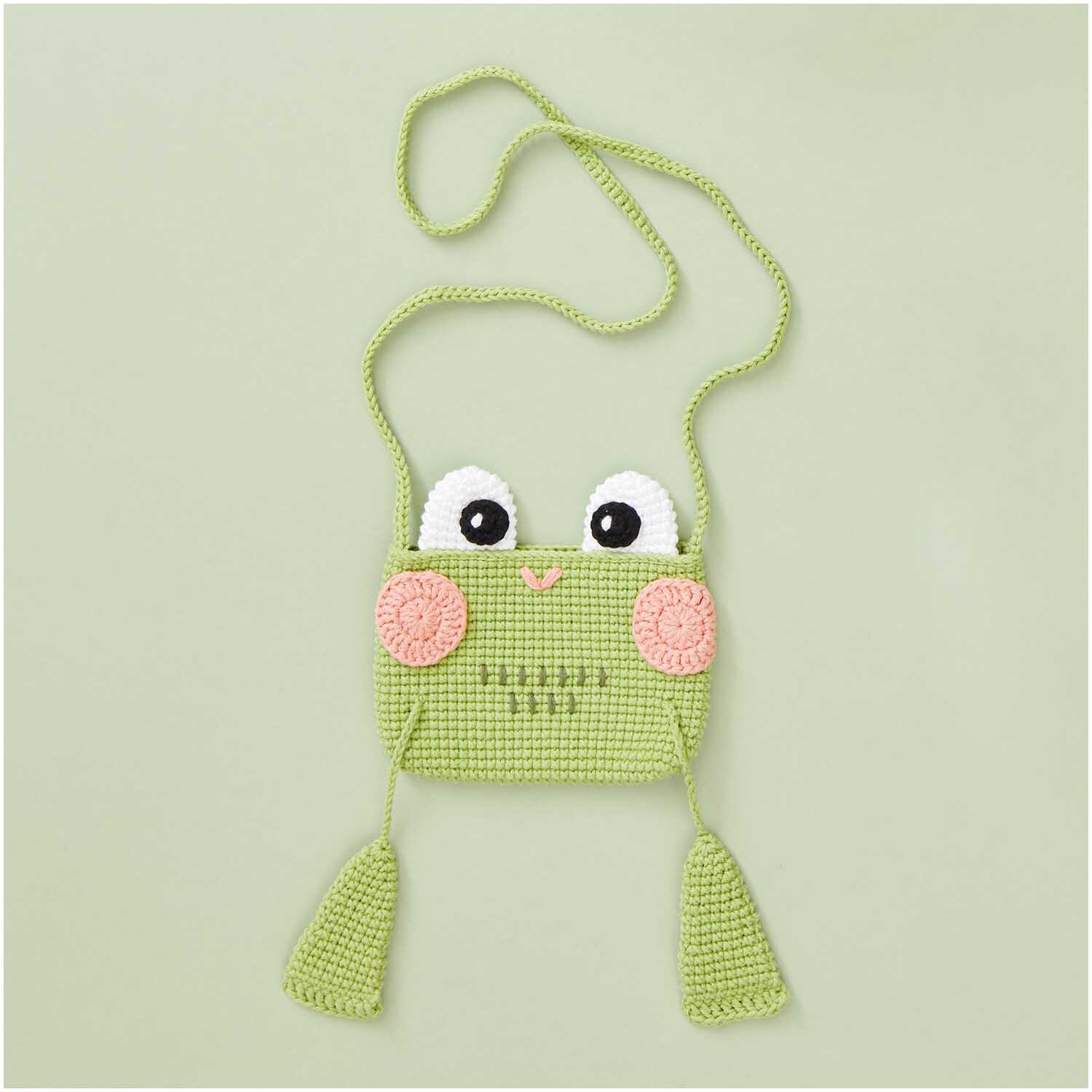 Creative Ricorumi dk: Niedliche, olivfarbene gehäkelte Froschtasche mit Augen und rosa Wangen von Rico Design. Ideal für Kinder.