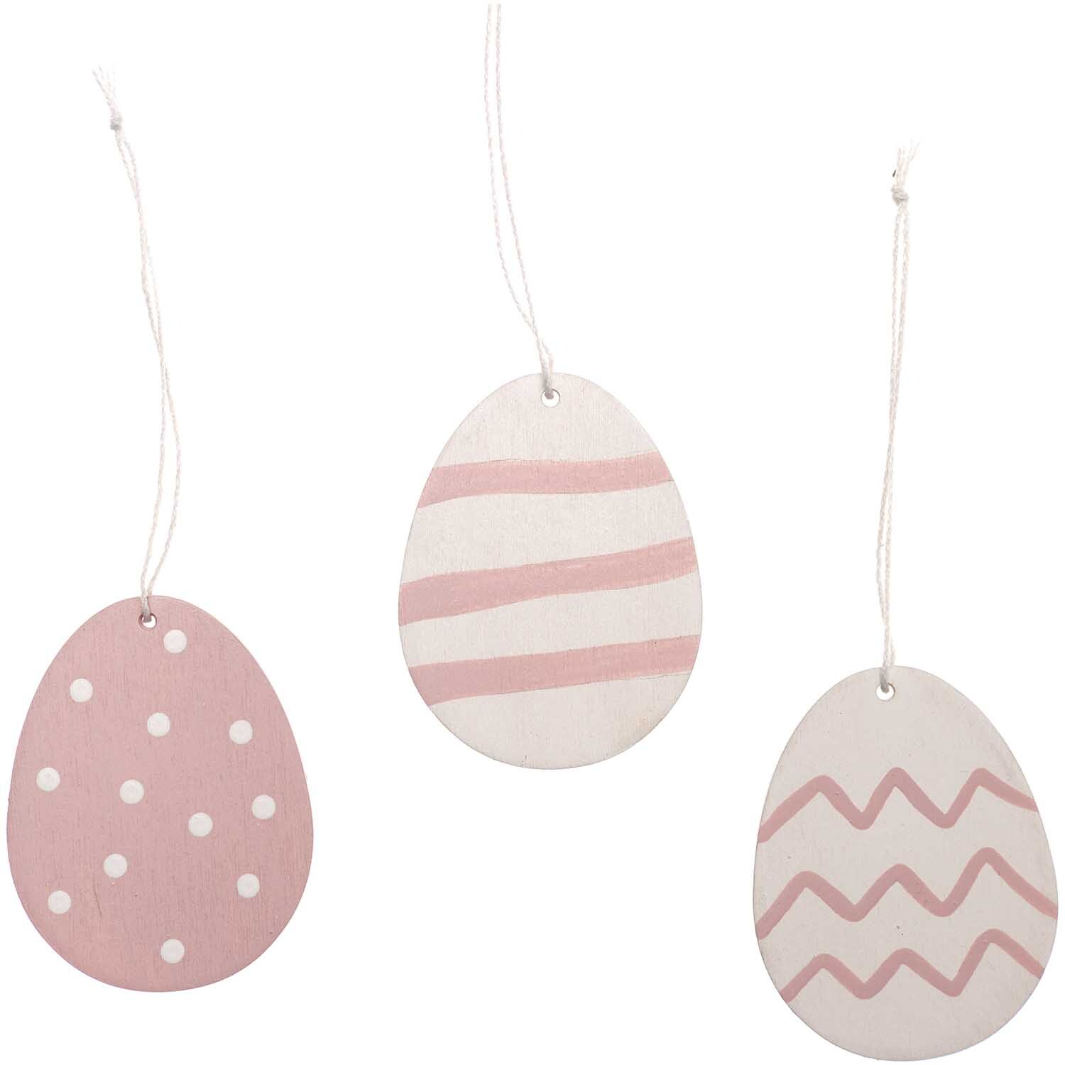 Holzhänger Osterei 3 Stück: Drei rosa Ostereier aus Holz mit verschiedenen Mustern von Rico Design.
