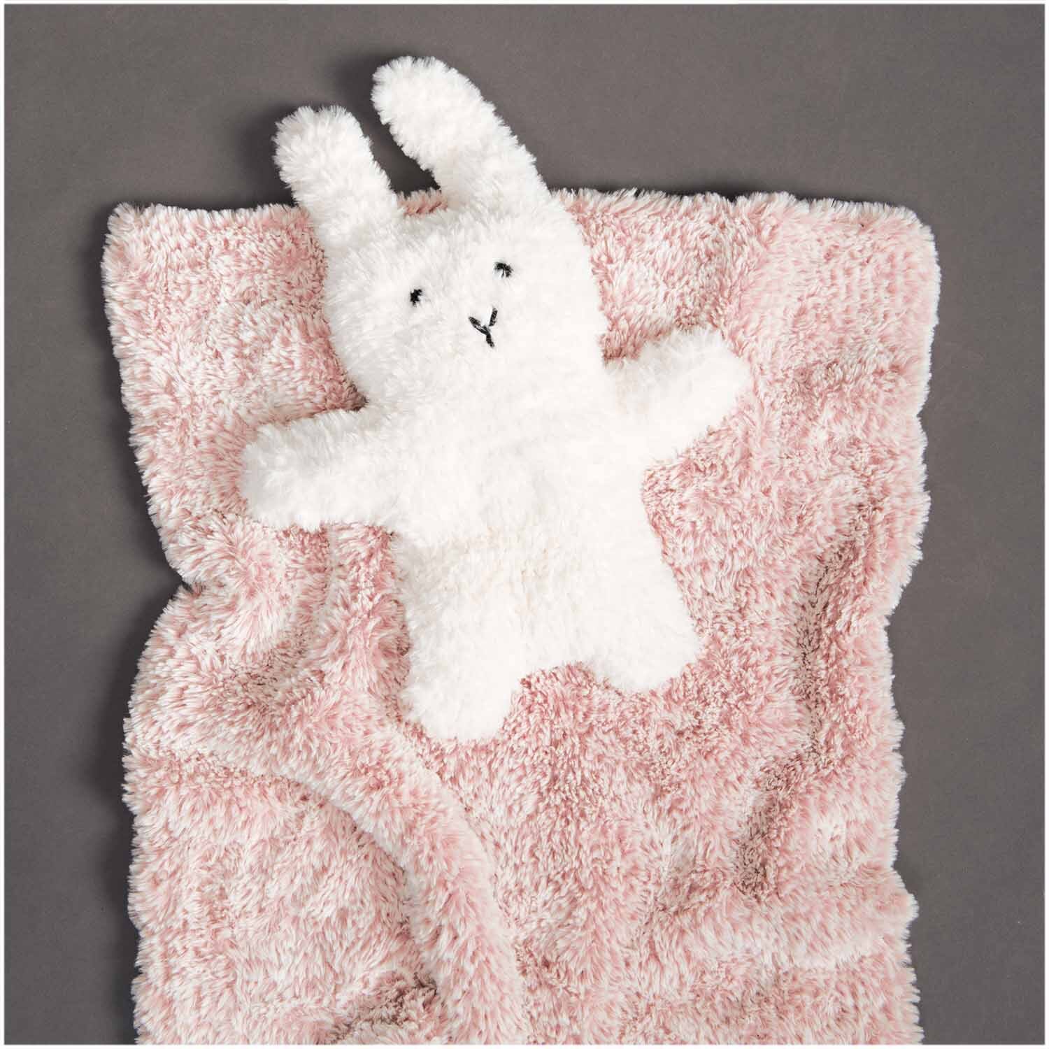 Creative Petit Lapin Super Chunky: Flauschige rosa Decke mit weißem Hasenmotiv, ideal für Kinderzimmer. Hochwertige Qualität von Rico Design.