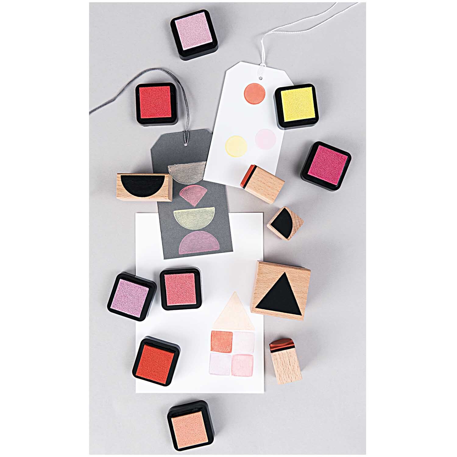 Paper Poetry Stempelset geometrische Symbole rund, 6-teilig, mit bunten Stempelkissen und Holzgriffen auf grauem Hintergrund.