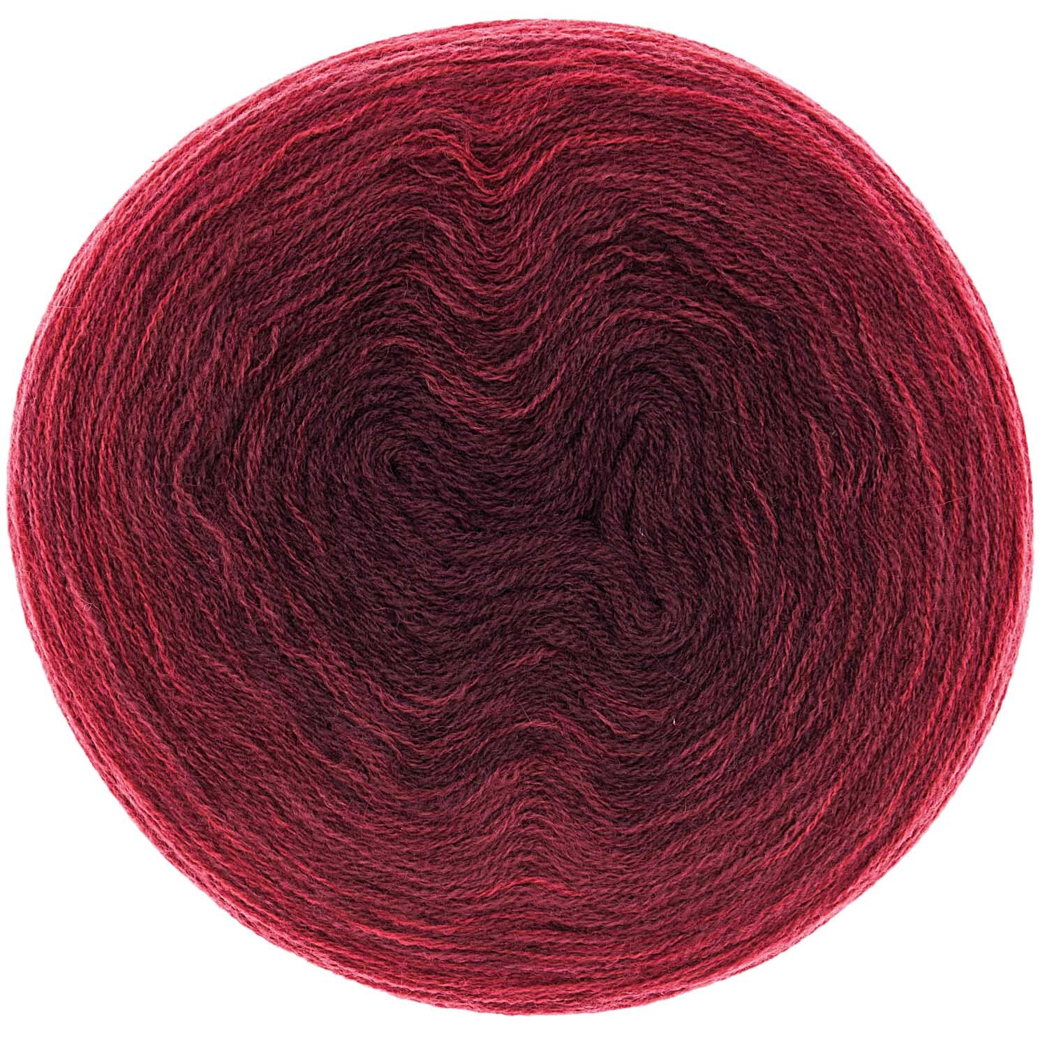 Creative Wool dégradé von Rico Design in Rot, 200g 800m. Das Bild zeigt ein rundes Wollknäuel.