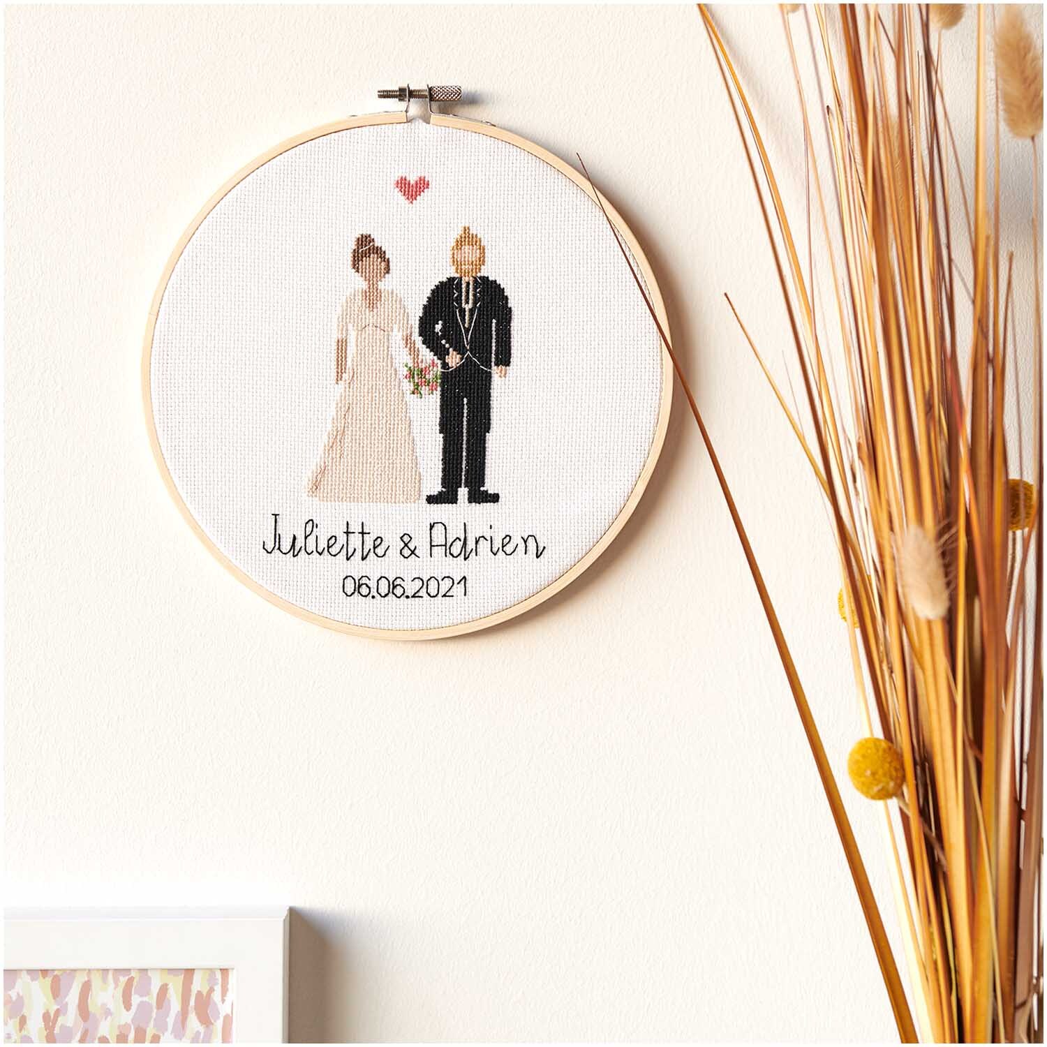 Figurico Stickpackung Wedding Ø 20cm zeigt ein gesticktes Hochzeitspaar mit Datum, umrahmt von einem Holzring.