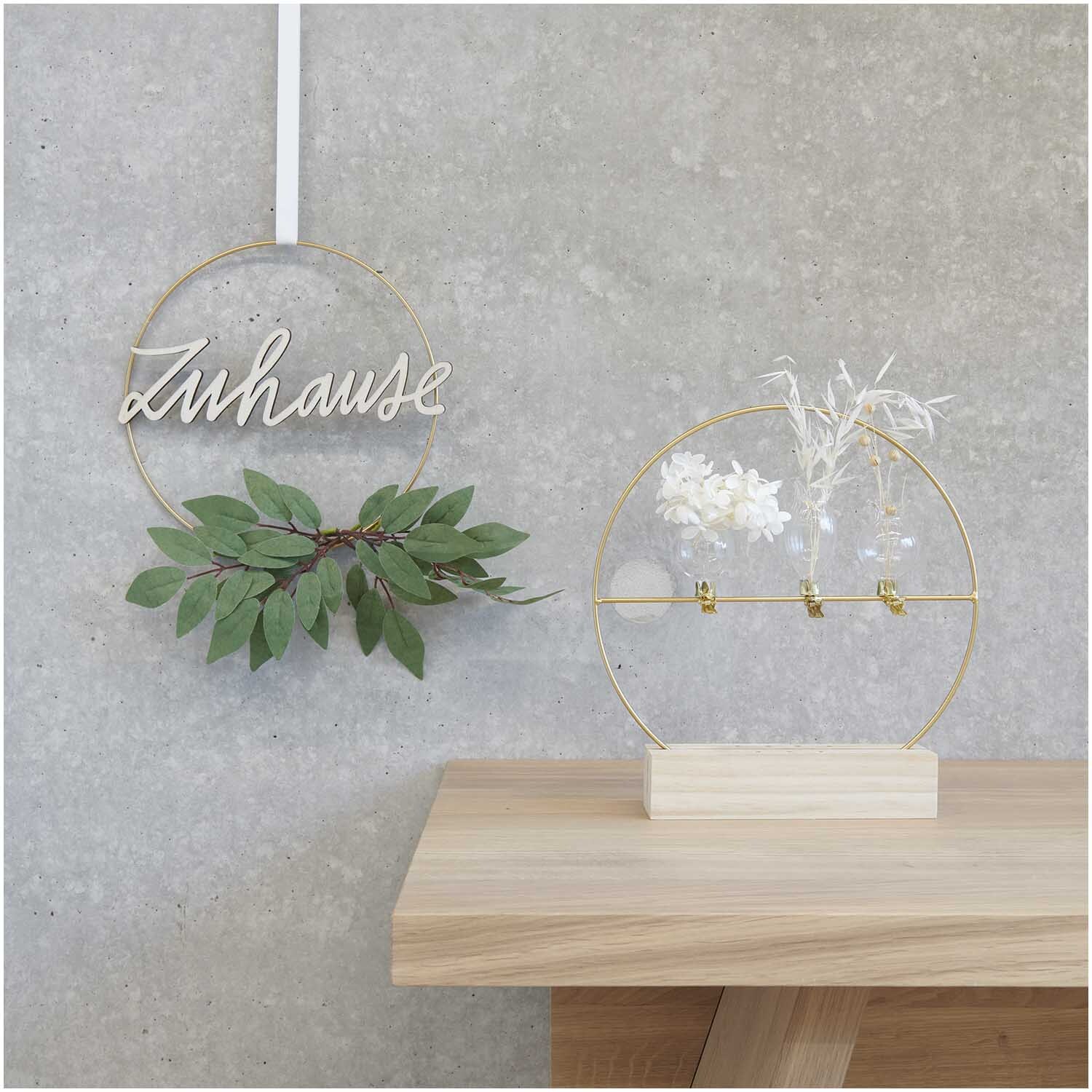 Metallring gold matt: Zwei dekorative Metallringe, einer mit "Zuhause"-Schriftzug und Blättern, der andere mit Trockenblumen auf Holzständer.