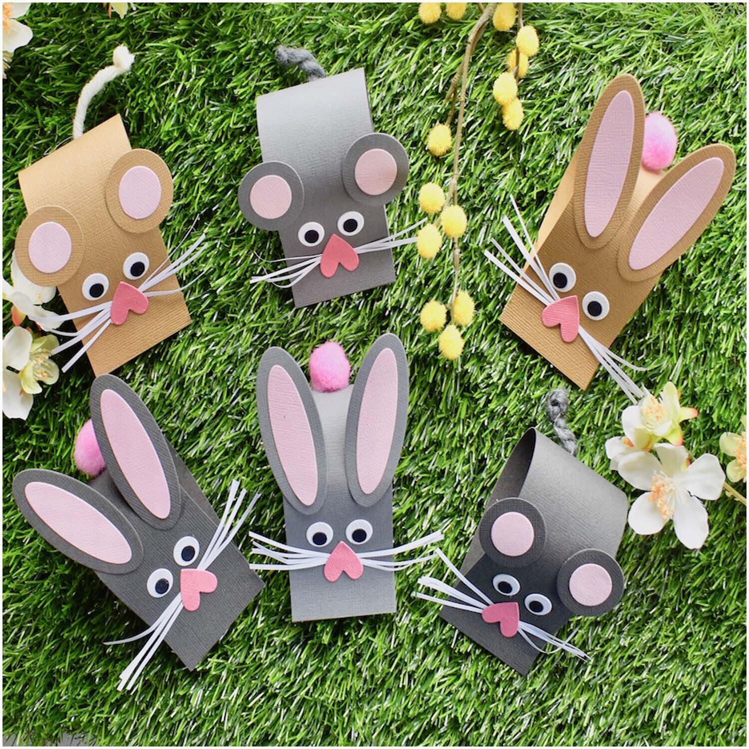 Framelits Die Set Ovals: Niedliche Tierfiguren aus Papier in verschiedenen Farben auf grünem Hintergrund.