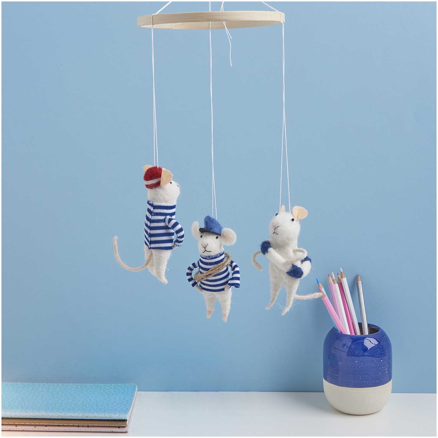 Filzhänger Maus mit Rettungsring 11cm: Drei Filzmäuse in Matrosenoutfits hängen an einem Holzring vor blauer Wand.
